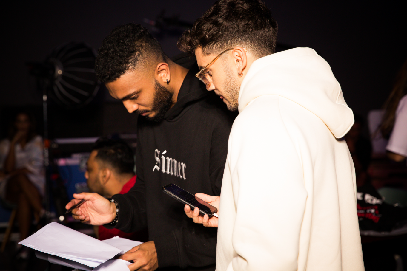 Nuwan reviewing production notes on set